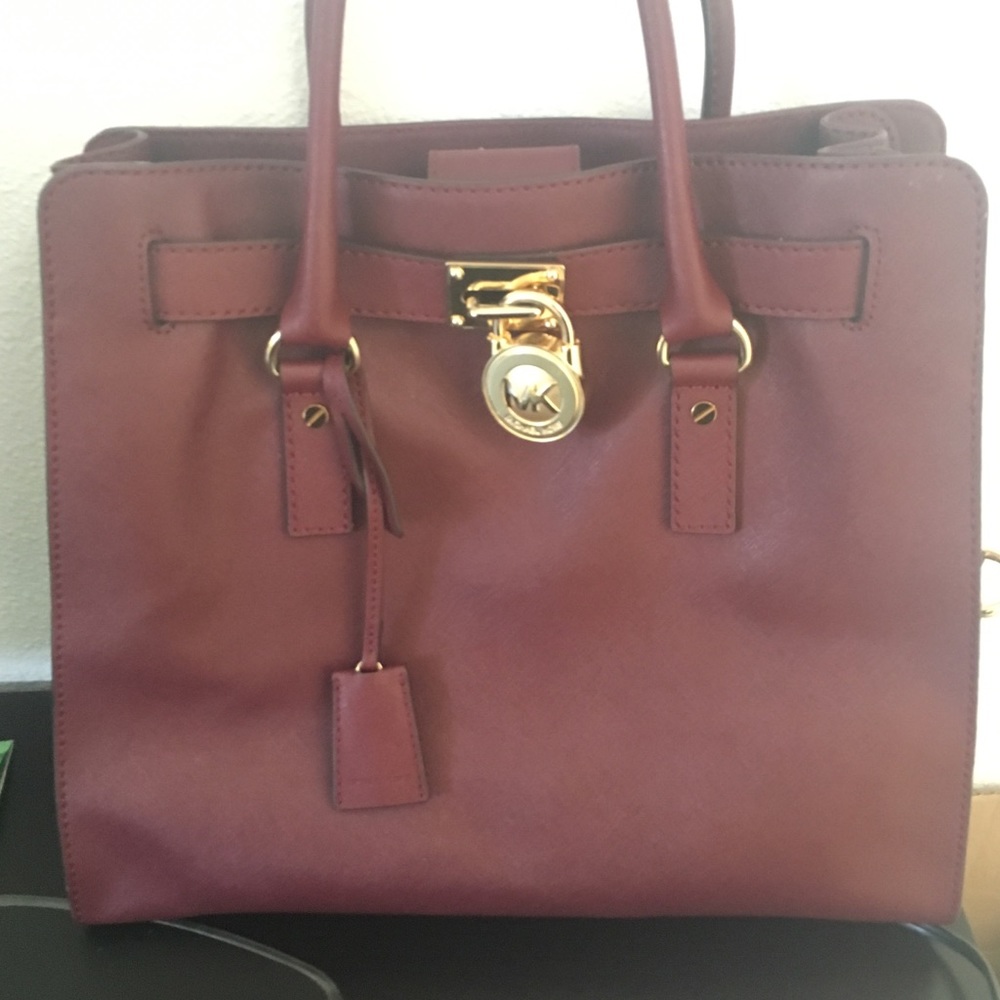 A maroon Michael Kors bag